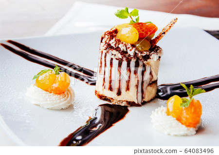Creamy cheesecake with with syrup glazed fruits 64083496