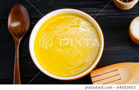 Carrot soup served on the table in bowl Carrot soup served on the table in bowl 64083603