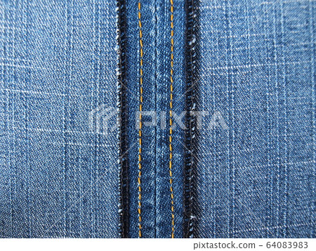 close up shot inside of jean seam. Blue jean skirt on the background showing the seam texture. close up shot inside of jean seam. Blue jean skirt on the background showing the seam texture. 64083983