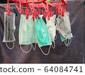 Dry mask Many masks for protection against Covid-19 were washed and hung for drying. To reuse it again because the mask was in short supply or expensive during the crisis. Selective focus 64084741