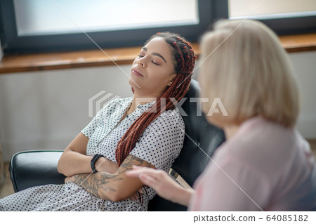 Young woman having a therapy session and feeling frustrated 64085182