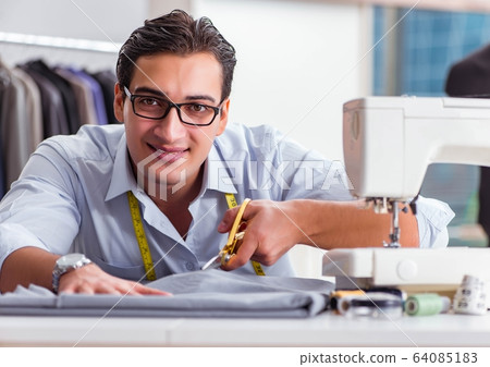 Young man tailor working on new clothing 64085183
