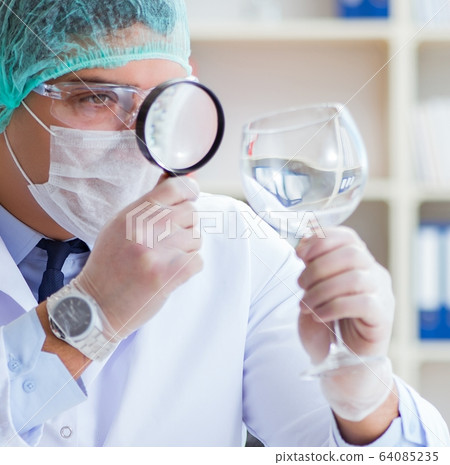 Forensics investigator working in lab on crime evidence 64085235