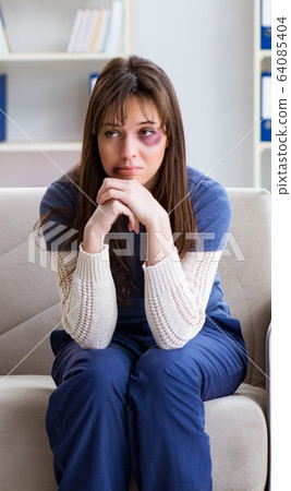 Psychologist counselling woman beaten by husband 64085404