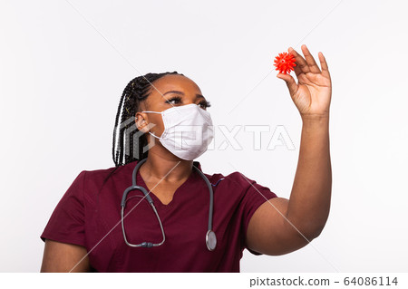 Covid-19, Vaccine development , outbreak and medicine concept - Doctor in medical protective mask holding a model of coronavirus. 64086114