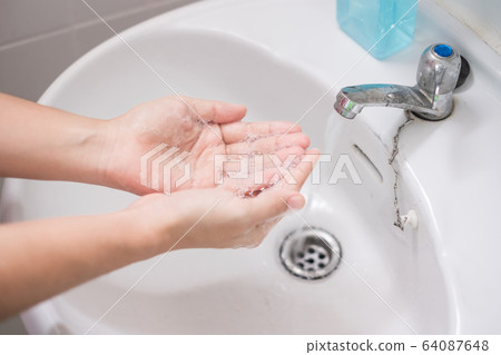 Woman Washing hands with liquid soap Step 1 64087648