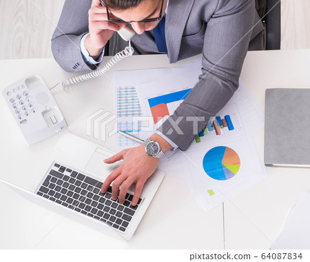 View from top on businessman working on business charts 64087834