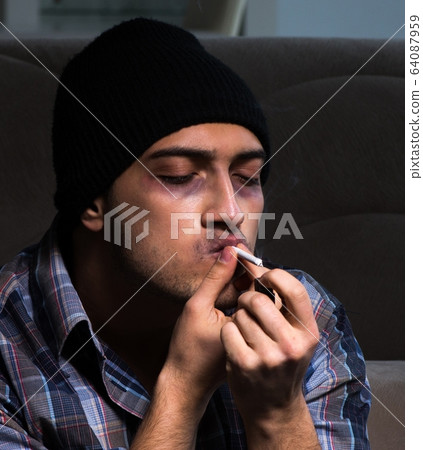 Young man in agony having problems with narcotics 64087959