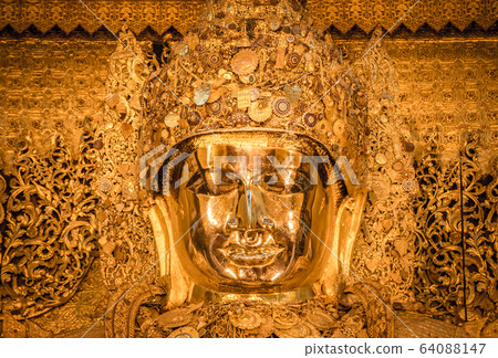 Mahamuni Buddha statue in Mahamuni temple of Mandalay, Myanmar. 64088147
