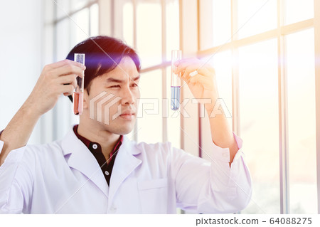 Scientist happy to successful discover new drug formula by choice select good chemical liquid 64088275