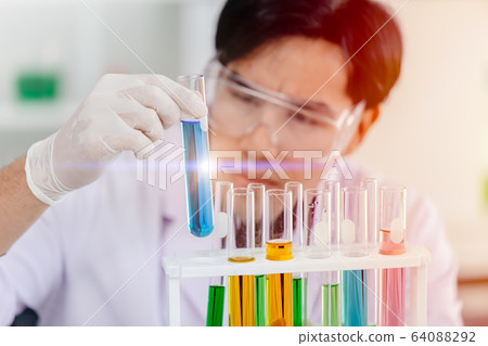 Scientist looking at chemical science test tube successful to discover new drug anti virus vaccine 64088292