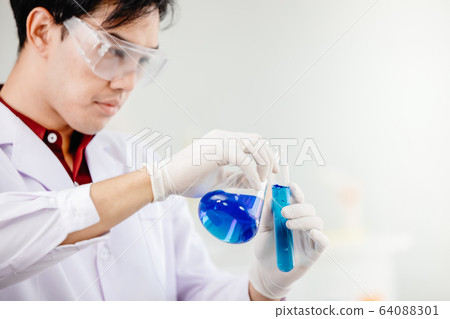 Scientist mixing chemical work in medical lab to research develop new vaccine drug 64088301
