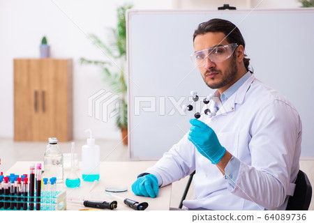 Young male chemist working in the lab 64089736