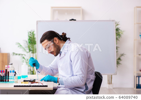 Young male chemist working in the lab 64089740
