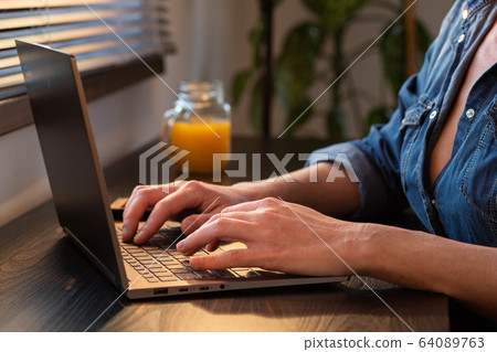 home office woman working on computer in sunset home office woman working on computer in sunset 64089763