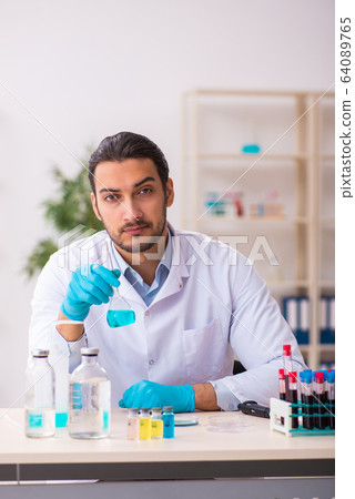 Young male chemist working in the lab Young male chemist working in the lab 64089765