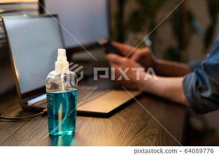 sanitizing computer or laptop keyboard coronavirus 64089776
