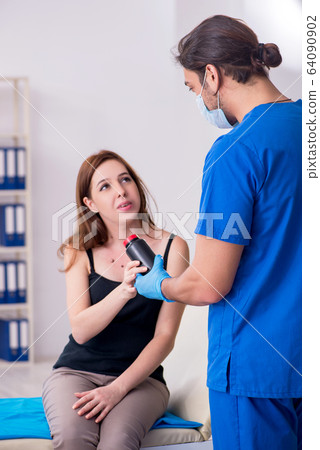 Young woman visiting male doctor dermatologist 64090902