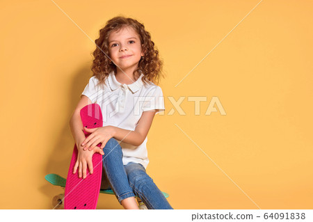Active and happy Kid having fun with penny board, smiling face stand skateboard. Penny board cute skateboard for girls. Lets ride. Girl ride penny board yellow background. Summer vacation Active and happy Kid having fun with penny board, smiling face stand skateboard. Penny board cute skateboard for girls. Lets ride. Girl ride penny board yellow background. Summer vacation 64091838