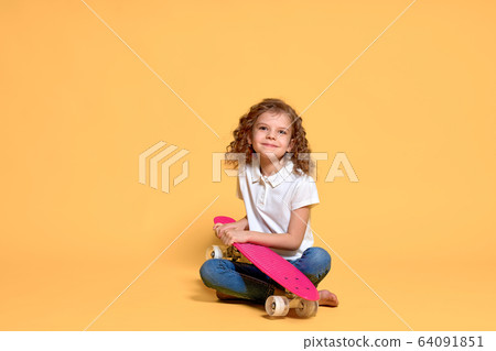 Active and happy Kid having fun with penny board, smiling face stand skateboard. Penny board cute skateboard for girls. Lets ride. Girl ride penny board yellow background. Summer vacation Active and happy Kid having fun with penny board, smiling face stand skateboard. Penny board cute skateboard for girls. Lets ride. Girl ride penny board yellow background. Summer vacation 64091851