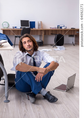 Young male employee unhappy with his work 64092271