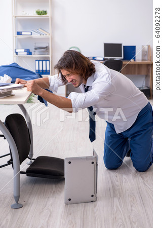 Young male employee unhappy with his work Young male employee unhappy with his work 64092278