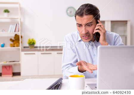 Young male businessman working at home 64092430