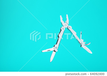 The multitool multi-function tool hovers on a blue 64092800