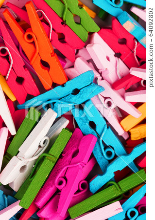 Small Clothespins of different colors close-up as 64092802