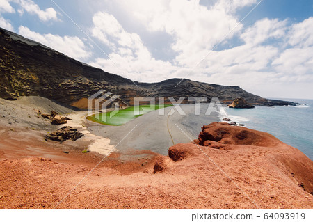 Volcanic crater with a green lake and ocean near El Golfo, Lanzarote, Spain. Volcanic crater with a green lake and ocean near El Golfo, Lanzarote, Spain. 64093919