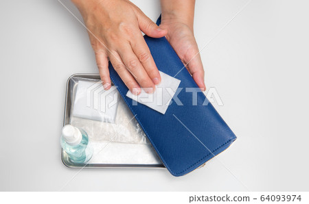 Cleaning wallet with alcohol to protection from covid-19 64093974