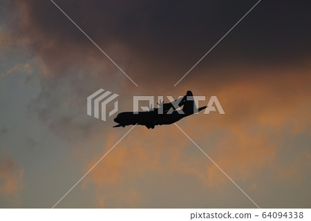 C-130 Hercules flying in the evening C-130 Hercules flying in the evening 64094338