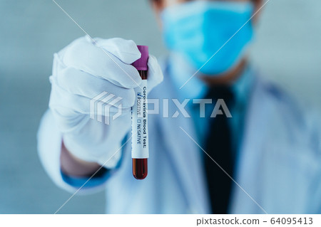 Asian male doctor holding blood Coronavirus (Covid 19) sample test for positive values. Wearing a protective mask. Corona Virus (2019-NCOV) Pandemic Respiratory disease Asian male doctor holding blood Coronavirus (Covid 19) sample test for positive values. Wearing a protective mask. Corona Virus (2019-NCOV) Pandemic Respiratory disease 64095413