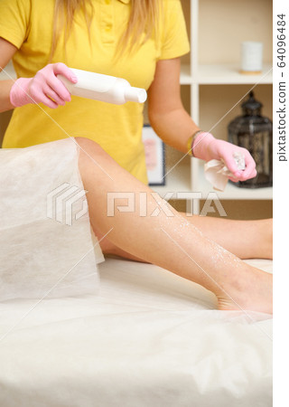 depilation and beauty concept - procedure of hair removing on leg beautiful woman with sugar paste or wax honey and pink gloves hand depilation and beauty concept - procedure of hair removing on leg beautiful woman with sugar paste or wax honey and pink gloves hand 64096484