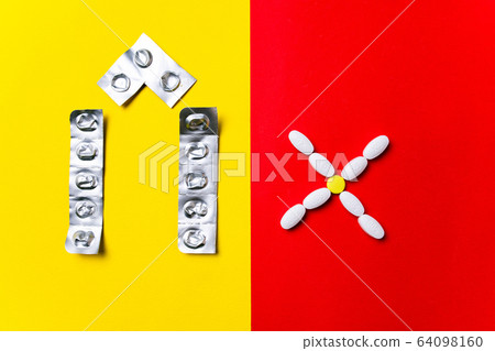 Colored pills, tablets and capsules on a red and yellow background - history of treatment, prevention of pandemic Colored pills, tablets and capsules on a red and yellow background - history of treatment, prevention of pandemic 64098160