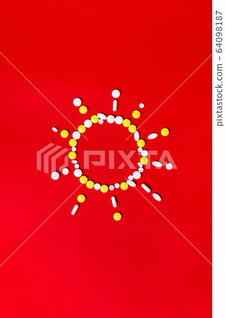 Colored pills, tablets and capsules on a red background - history of treatment, prevention of pandemic Colored pills, tablets and capsules on a red background - history of treatment, prevention of pandemic 64098187