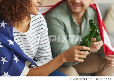 American Couple Drinking Beer Close Up American Couple Drinking Beer Close Up 64098634