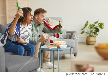 Emotional Couple Cheering for American Team 64098651