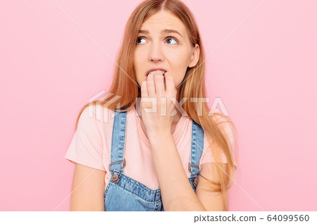 Nervous insecure scared young woman looks away, 64099560