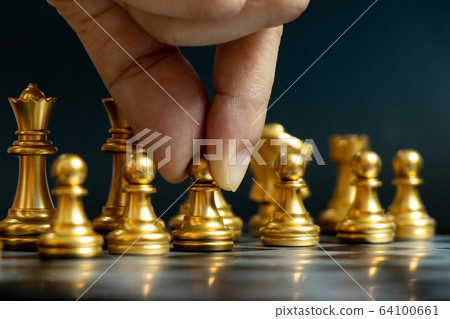 Business man hold pawn to move in chess game 64100661