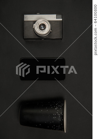 Gadgets and eyewear. Monochrome stylish composition in black color. Top view, flat lay. 64100800