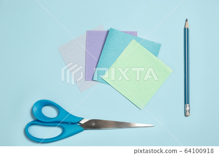 Sticker papers, scissors, pen. Monochrome stylish composition in blue color. Top view, flat lay. 64100918