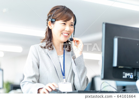 Young female operator talking on income 64101664