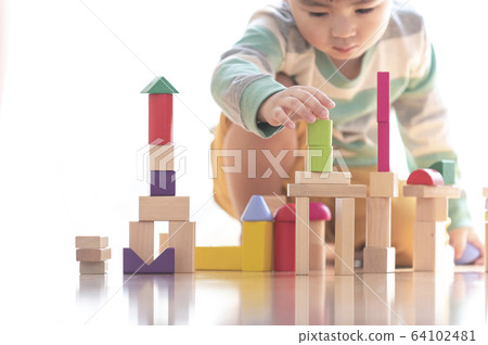 Boy playing with building blocks Boy playing with building blocks 64102481