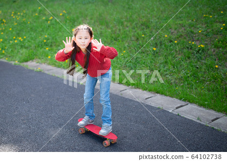 Girl with skateboard Girl with skateboard 64102738