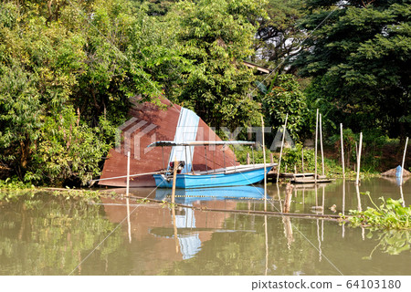 Traditional Thai house by the water Traditional Thai house by the water 64103180