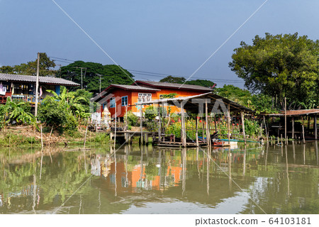 Traditional Thai house by the water 64103181