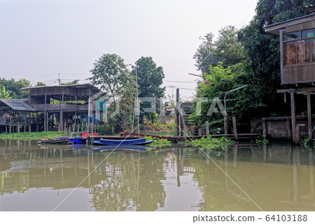 Traditional Thai house by the water 64103188