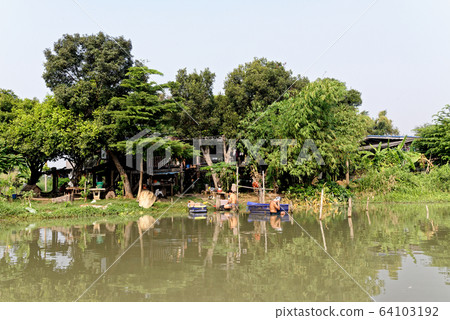 Traditional Thai house by the water Traditional Thai house by the water 64103192