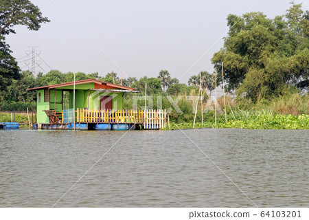 Traditional Thai house by the water Traditional Thai house by the water 64103201